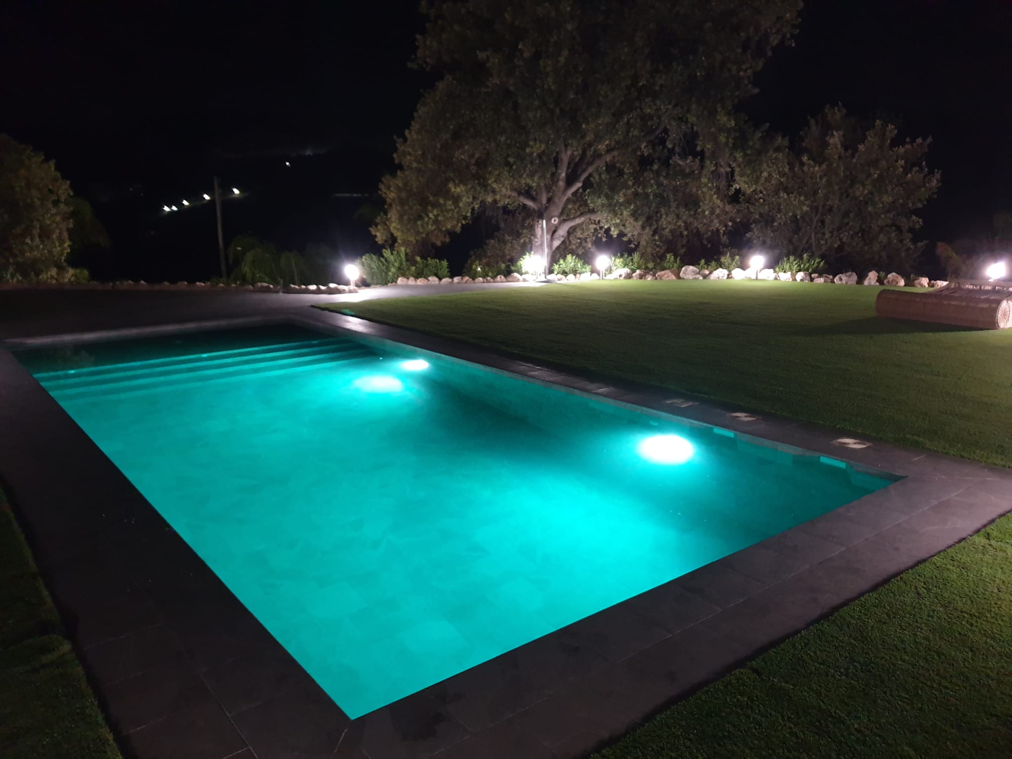 Outdoor terrace dining area overlooking olive grove and mountain views